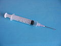 A typical plastic medical syringe, fitted with a detachable stainless steel needle