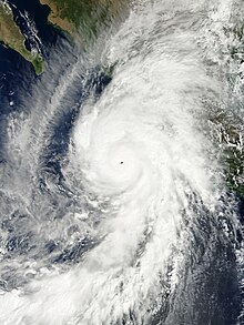 An exceptionally well-developed hurricane located southwest of Mexico. The storm features a well-defined, clear eye surrounded by a large, mostly symmetric ring of clouds. Prominent bands of cloud cover extend north and south of the storm center.