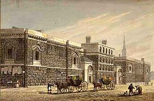 Engraving of large dark stone-block building, with horse-drawn carriages in the street in front