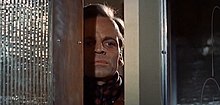 Klaus Kinski peaking through an ajar door