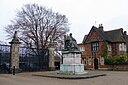 ☎∈ Statue of Robert Arthur Talbot Gascoyne-Cecil, 3rd Marquess of Salisbury in front of the park gates of Hatfield House.