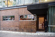 The old facade of the restaurant had exterior walls of wood and glass.