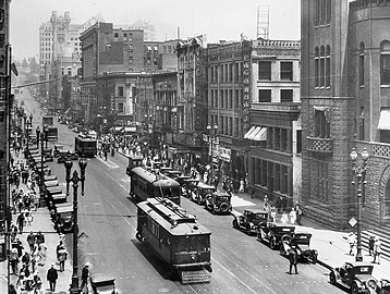 Looking north along Broadway at its east side past 2nd Street. From top left: The L.A. Times Bldg. with castle-like turret, with the 1911 Hall of Records behind it. The Chamber of Commerce Bldg. at #128. Drugstore in the Hellman Bldg. (#144–6) at the NE corner of 2nd Street. Dentist in the Nolan, Smith and Bridge Bldg. (#200–4) at the SE corner of 2nd. New King Hotel in the Gordon Bldg. (#206–10). Victor Clothing in its location from 1926 to 1964 in the Crocker Bldg. (#212–6). Pig 'n Whistle in the Copp Bldg. (#218–224). 1888 City Hall at far right