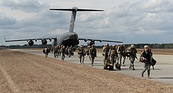 US Air Force personnel participating in Exercise Scorpion Lens 15 disembark a C-17 Globemaster III at North Auxiliary Airfield during 2015.