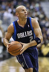 Kidd gripping a basketball and starting to leap