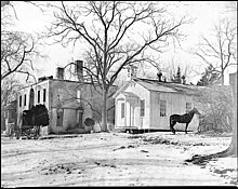 Photograph of a white house after being burnt