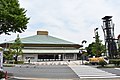 Street view showing the entrance of the arena, the Kokugikan is seen afar, a tower guards the entrance