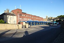 The old (pre-rebuild) bus station in Durham with a Go North East 'Diamond' branded bus & three Arriva North East buses at bus stands.