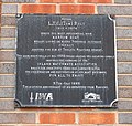 Plaque attached to retaining wall of Tom Rolt Bridge on mooring side of canal