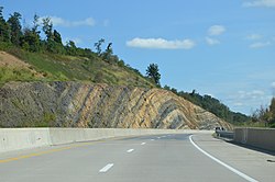 A road cut along U.S. Route 322 with visible anticline rock strata