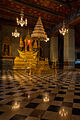 The Royal Nine-Tiered Umbrella (Nobapadol Mahasvetachatra) attached to a throne inside a hall in the Grand Palace, Bangkok. Only a crowned king can use an umbrella with nine-tiers, until then he must make do with only seven.