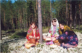 Three Khanty girls gathering berries