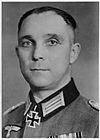 A black-and-white photograph of a man wearing a dark military uniform with a neck order in shape of an Iron Cross.