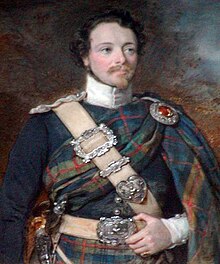 Young man with a goatee, wearing a kilt and full plaid in Atholl Highlanders/Murray of Atholl tartan, a blue military doublet, a white sword belt, a white high-collared shirt, and a Highland dirk