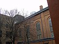 Courtyard view, showing Ss. Peter & Paul Jesuit Church's cross and the General Motors logo