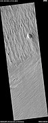 Wide view of yardangs, as seen by HiRISE under HiWish program This image is odd in that the yardangs are lined up in different directions in the top and bottom part of image. The wind direction probably changed to cause this. Location is Memnonia quadrangle.