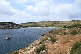 A photograph showing Mistra Bay and surrounding land.