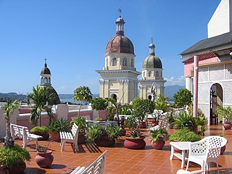 Terrasse sur le toit de l'hôtel Casa Grande, à Santiago de Cuba. À l'arrière-plan, sont visibles les tours de la cathédrale Nuestra Señora de la Asunción. (définition réelle 2 272 × 1 704)