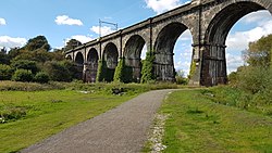 A photograph of the Sankey Viaduct in 2016 with the overhead line equipment for electric trains visible