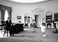 John F. Kennedy's children visit the Oval Office.