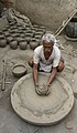 Image 12 Potter Photo: Yann A potter at work in Jaura, Madhya Pradesh, India. Pottery, defined by ASTM International as "all fired ceramic wares that contain clay when formed, except technical, structural, and refractory products", originated during the Neolithic period. More selected pictures