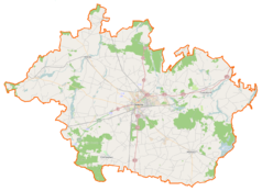 Mapa konturowa powiatu gnieźnieńskiego, w centrum znajduje się punkt z opisem „Wojewódzki Szpital dla Nerwowo i Psychicznie Chorych „Dziekanka”im. Aleksandra Piotrowskiegow Gnieźnie”