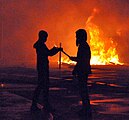 Protestors lighting a Molotov cocktail