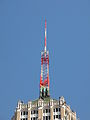 An antenna tower 146 feet (45 m) tall in San Antonio, TX with its red and white aircraft warning paint visible