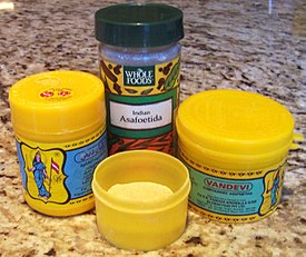 Jars of commercially available asafoetida powder.