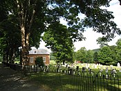 The small church and cemetery, behind the iron fence