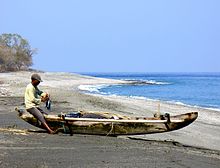 A fisher and fishing canoe at Maubara in 2006