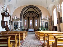 Vue intérieure de la nef vers le chœur avec la chaire et les autels (XIXe).