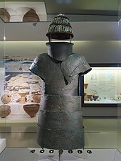 Bronze armour and a helmet with pieces of boar's tusk