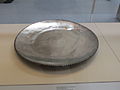 Serving plate with a rim decorated with bead and reel