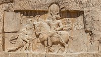 Rock relief at Naqsh-e Rustam; the Persian Sassanian emperor Shapur I (on horseback) with Roman emperors submitting to him