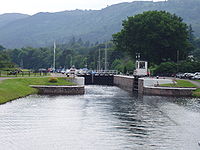 The Dochgarroch Lock along the Caledonian Canal with its lower gates open. The upper gates leading to Loch Dochfour are closed.