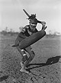 Image 34A Luritja man demonstrating method of attack with boomerang under cover of shield (1920) (from Culture of Australia)