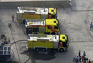 This is a photo of Dubai Civil Defense vehicles at the base of the under-construction Fortune Executive Tower (located in Jumeirah Lake Towers in Dubai, United Arab Emirates) due to a fire there on 15 June 2008.