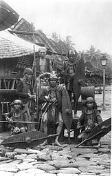 Group portrait of men dressed as warriors, South Nias