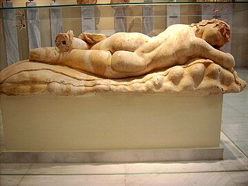 Statue of a sleeping Maenad, lying on a panther skin spread on a rocky surface; the type is known as the reclining Hermaphrodite; Pentelic marble; found at the south of the Athenian Acropolis; Hadrianic time (117–138 AD), follows a classical trend in Attic art; National Archaeological Museum, Athens.