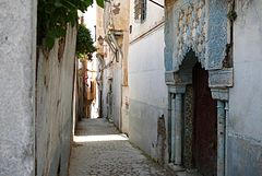 Une ruelle étroite avec l'entrée ornementée d'une maison.