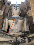 Large white seated Buddha statue.