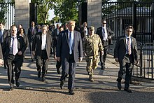 Milley wearing combat uniform walking behind Trump while escorting the President from the White House to St. John's Episcopal Church
