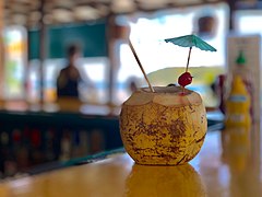 Coconut with straw at restaurant in Esperanza, Vieques