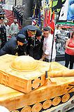 Buddy Valastro (right), General Raymond T. Odierno and other members of the United States Army in Times Square cutting a cake to celebrate the Army's 237th birthday in 2012