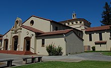 A church with white walls and a brown roof