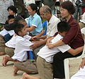 Image 28Display of respect of the younger towards the elder is a cornerstone value in Thailand. A family during the Buddhist ceremony for young men who are to be ordained as monks. (from Culture of Thailand)