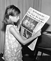 Image 24A girl reading a 21 July 1969 copy of The Washington Post reporting on the Apollo 11 Moon landing (from Newspaper)