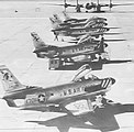 F-86Ds assigned to the 86th FIS at Youngstown Airport, Ohio, line the Yuma ramp in front of a TB-29A target tug during the summer of 1955.