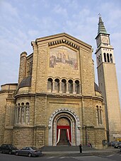 The photo shows the parish church, dedicated to the Saints Peter and Paul, known as "New Church", built in 1934 in a new area of the city.